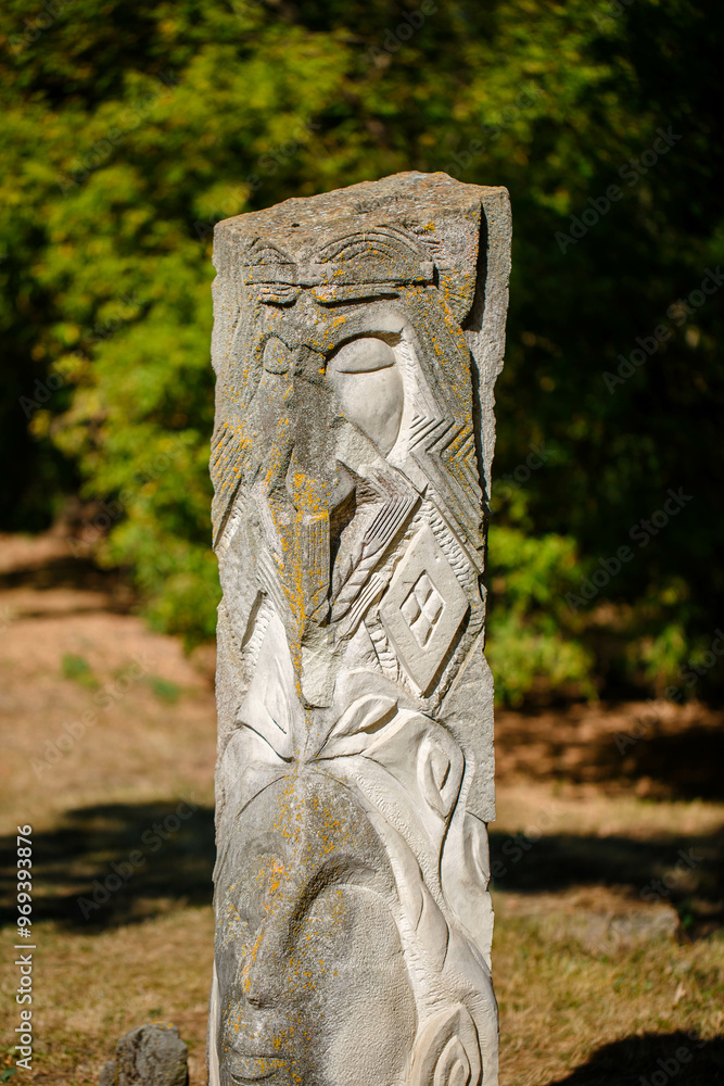 The figure of the ancient gods on the stones in the autumn park. Ukraine. Scythian culture
