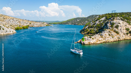 An aerial view of the stunning Krka Canyon located between Šibenik and Bilice in Croatia. The canyon winds through lush landscapes and dramatic cliffs, with the Krka River  photo