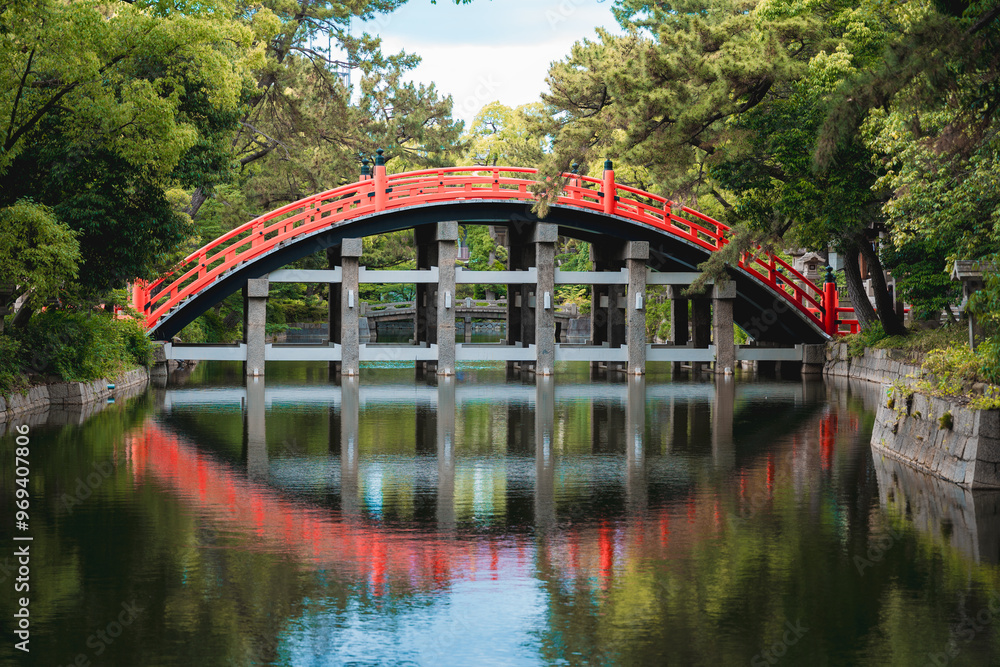 Traditional Japanese Red Arch Bridge Reflecting in Calm Water Traditional Japanese Red Arch Bridge Reflecting in Calm Water