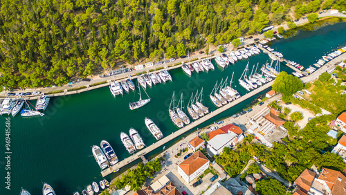 An aerial view of Skradin, a charming town near Krka National Park in Croatia. Nestled along the Krka River, the town features a picturesque marina filled with yachts and boats. photo