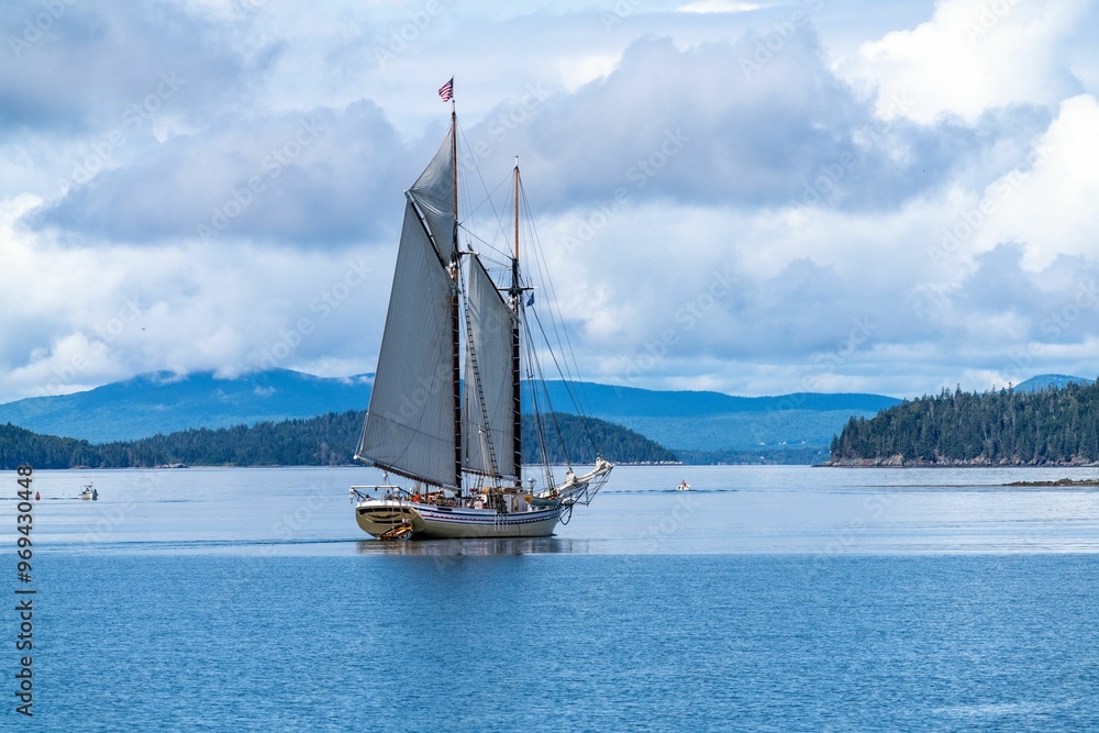 Fototapeta premium Tourist schooner anchored in NW Harbor, Deer Isle, Maine, USA on a clear day