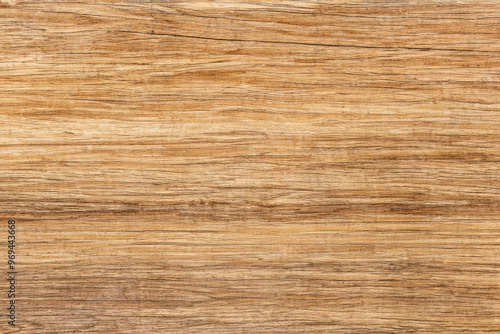 Close-up of a wood texture, featuring natural brown and light brown grain patterns, with subtle lines throughout the surface.