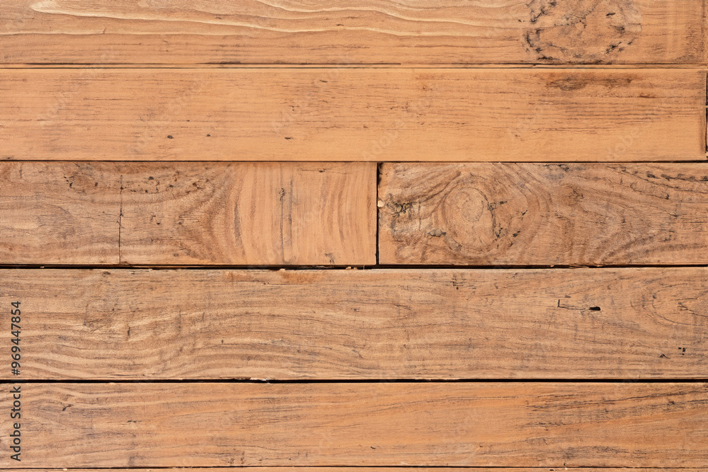 Close-up of rustic wooden planks with a natural grain pattern and subtle knots. Close-up of rustic wooden planks with a natural grain pattern and subtle knots.