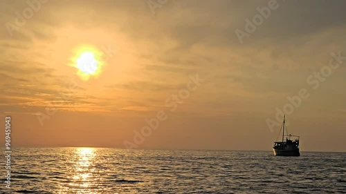 Boat floting with beautiful sunset in the sea