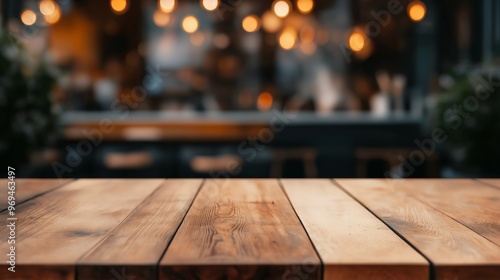 Wooden table with blurred cafe background, warm bokeh lights, and cozy atmosphere.