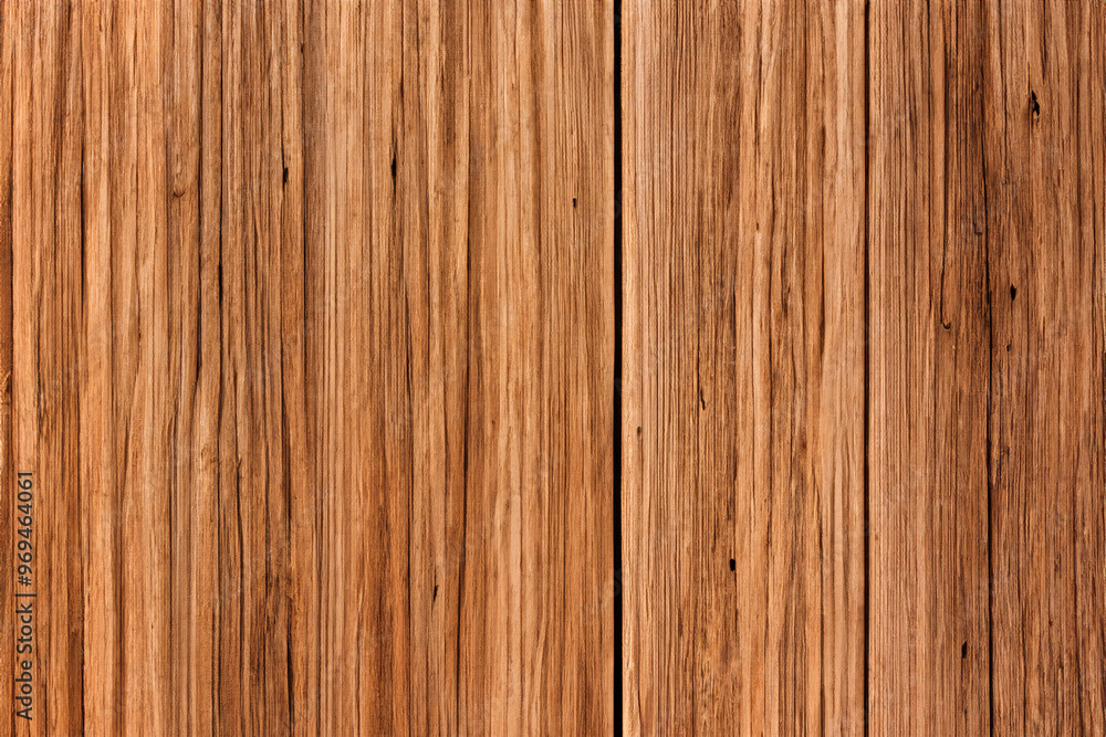 Closeup of a rustic wooden plank wall with a vertical grain pattern. Closeup of a rustic wooden plank wall with a vertical grain pattern.