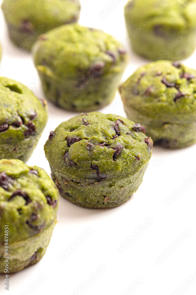 Bright Green Spinach Chocolate Chip Mini Muffins Isolated on a White Background Bright Green Spinach Chocolate Chip Mini Muffins Isolated on a White Background