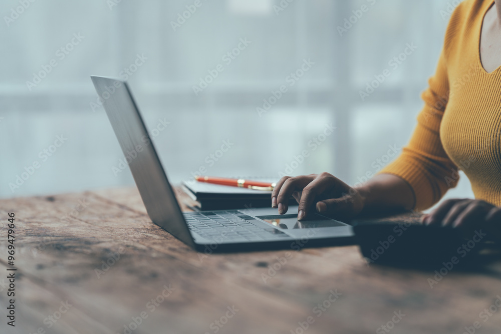 Fototapeta premium Financial Focus: Woman Analyzing Data on Laptop