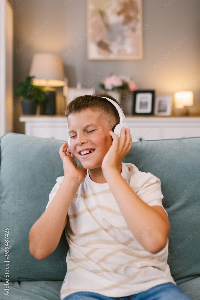 Young Boy Smiling with Headphones on Couch Young Boy Smiling with Headphones on Couch