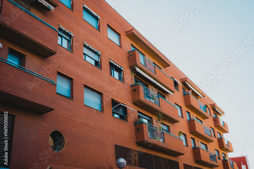 Behold a breathtaking and stunning view of a modern residential building showcasing textured brick and vibrant windows in Tarragona, Spain