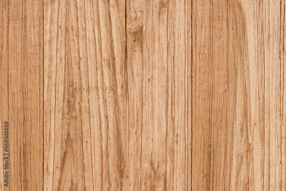 Close-up of a light brown wooden surface with vertical grain patterns. Close-up of a light brown wooden surface with vertical grain patterns.
