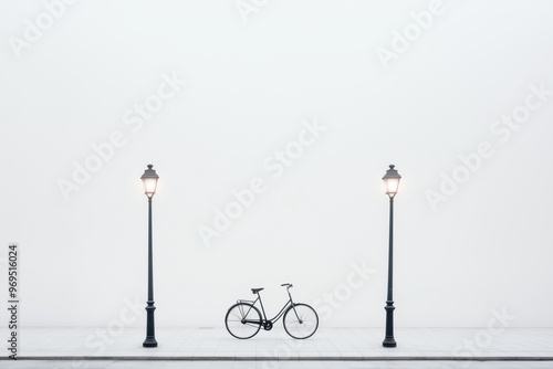 Minimalist Bicycle Scene:  A lone bicycle rests between two streetlamps against a stark white wall, creating a simple yet striking visual composition.   photo