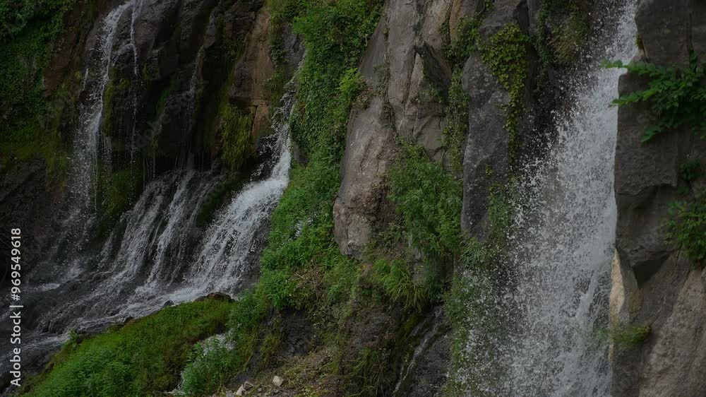 The Serene Waterfall Gracefully Cascading Down Majestic Rocky Cliffs Surrounded by Lush Greenery The Serene Waterfall Gracefully Cascading Down Majestic Rocky Cliffs Surrounded by Lush Greenery