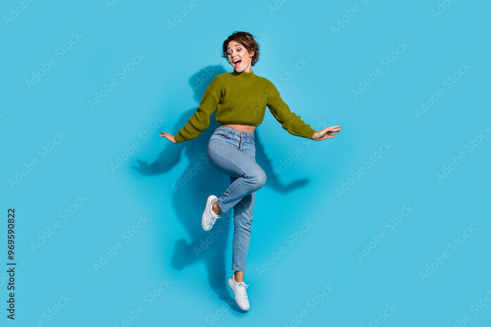 Full length photo of glad satisfied girl wear trendy clothes look down empty space banner news isolated on cyan color background Full length photo of glad satisfied girl wear trendy clothes look down empty space banner news isolated on cyan color background