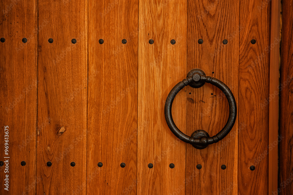 Rustic wooden door with iron rivets and knocker Rustic wooden door with iron rivets and knocker