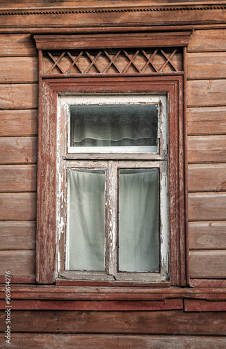 Old wooden window on the ancient abandoned house