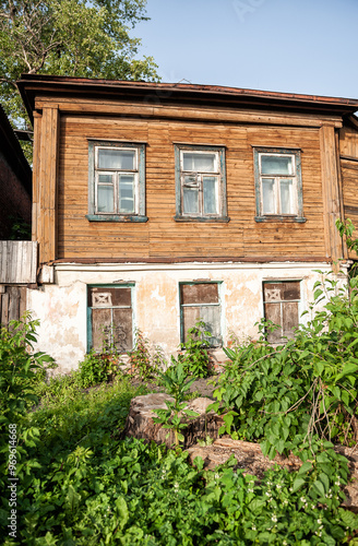 Photos Rustic, abandoned house with a deteriorating facade and broken and boarded up wi