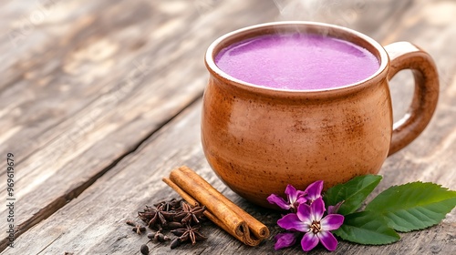 Traditional Andean api morado served in a rustic clay mug, with steam rising from the warm purple drink. The thick, spiced beverage fills the air with rich, comforting aromas of cinnamon and  photo