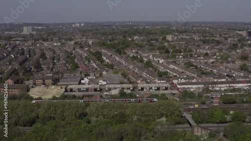 Drone shot over Tottenham Hale neighborhood including modern high and low rise developments with City of London in the background London, UK photo