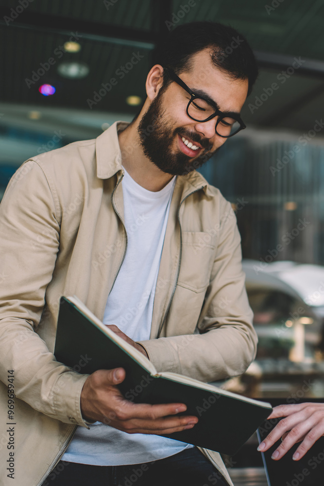 Ethnic man sharing data with female colleague