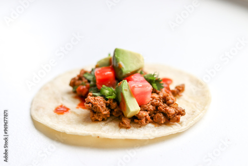 Taco with avocado and tomato