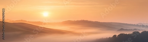 Misty sunrise over rolling hills with golden light.