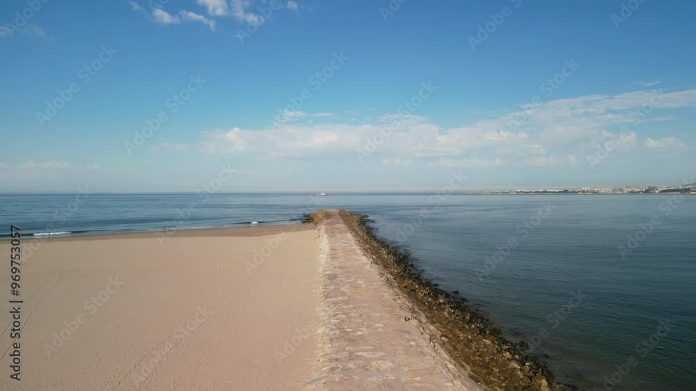 Aerial of Atlantic Ocean with sandy beach on a sunny day with blue sky in Trafaria, Lisbon, Portugal Aerial of Atlantic Ocean with sandy beach on a sunny day with blue sky in Trafaria, Lisbon, Portugal