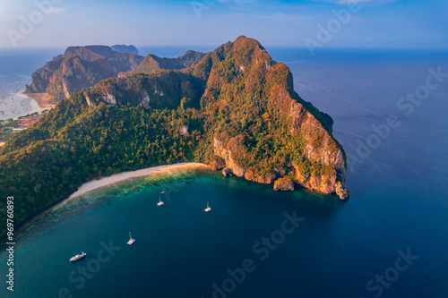 Aerial view landscape with sunrise on Phi Phi with white yacht catamaran in Thailand. Tourist boat trip in Thai travel concept photo