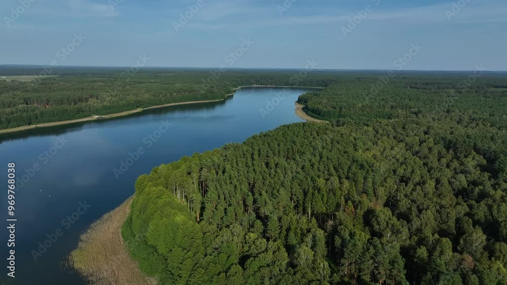 View of Serene river lake surrounded by green forest. View of Serene river lake surrounded by green forest.