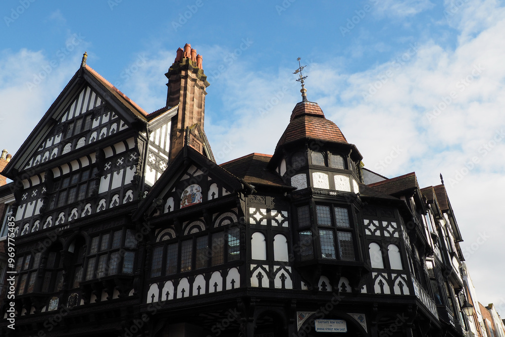Fototapeta premium Old half timbered buildings on the corner of Eastgate and bridge street with stairs leading to the upper rows in Chester