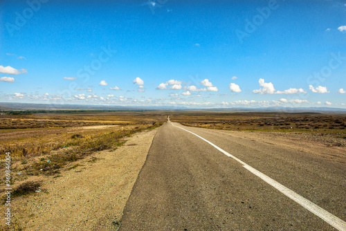 Paved two-lane road in semi-desert area photo