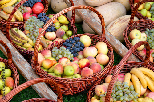 Photography Baskets filled with assorted fresh fruits, including apples, grapes, bananas, an