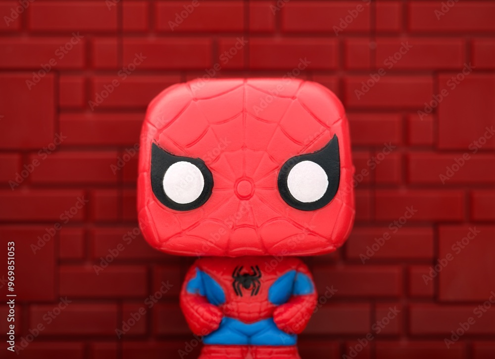 Obraz premium Tambov, Russian Federation - August 23, 2024 Spider-Man Funko POP Mini Vinyl Figure against a red brick wall background.