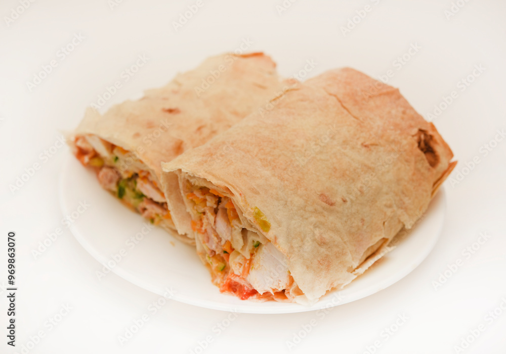 Meat shawarma on a white plate. Burritos with meat. Meat shawarma on a white plate. Burritos with meat.