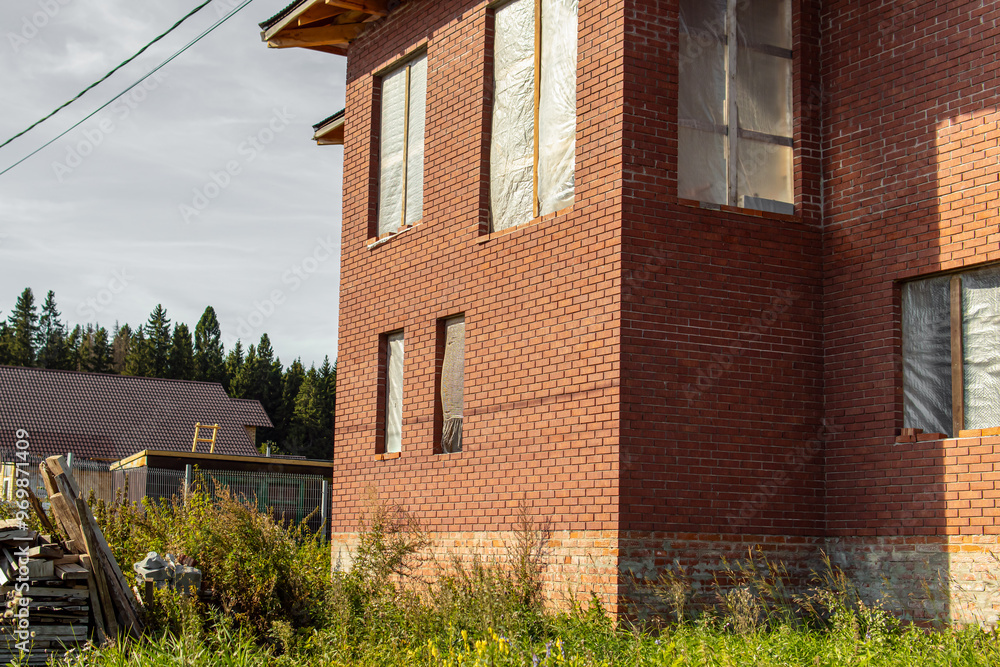 Unfinished two-storey brick house. High foundation. An abandoned house Unfinished two-storey brick house. High foundation. An abandoned house