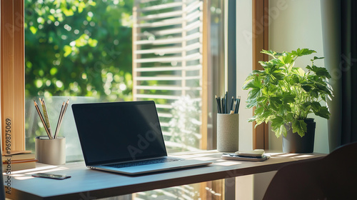 Wallpaper Mural Minimalist Workspace with Laptop and Green Plant Next to Window in a Sunlit Room Torontodigital.ca