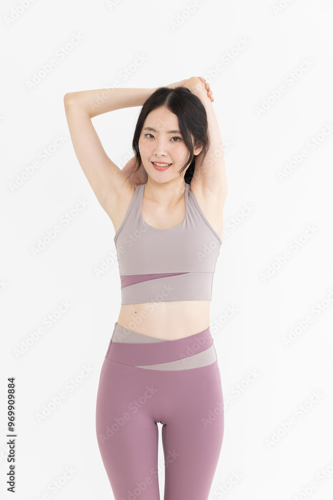 Isolated asian woman with shoulder stretching pose Isolated asian woman with shoulder stretching pose