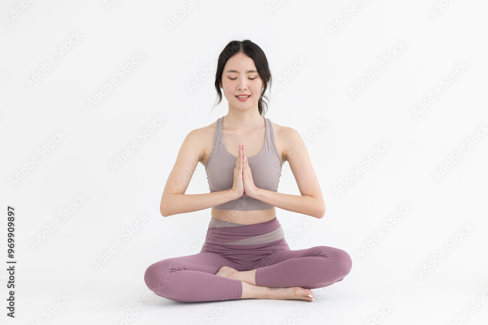 Isolated asian woman in lotus yoga position on white background Isolated asian woman in lotus yoga position on white background