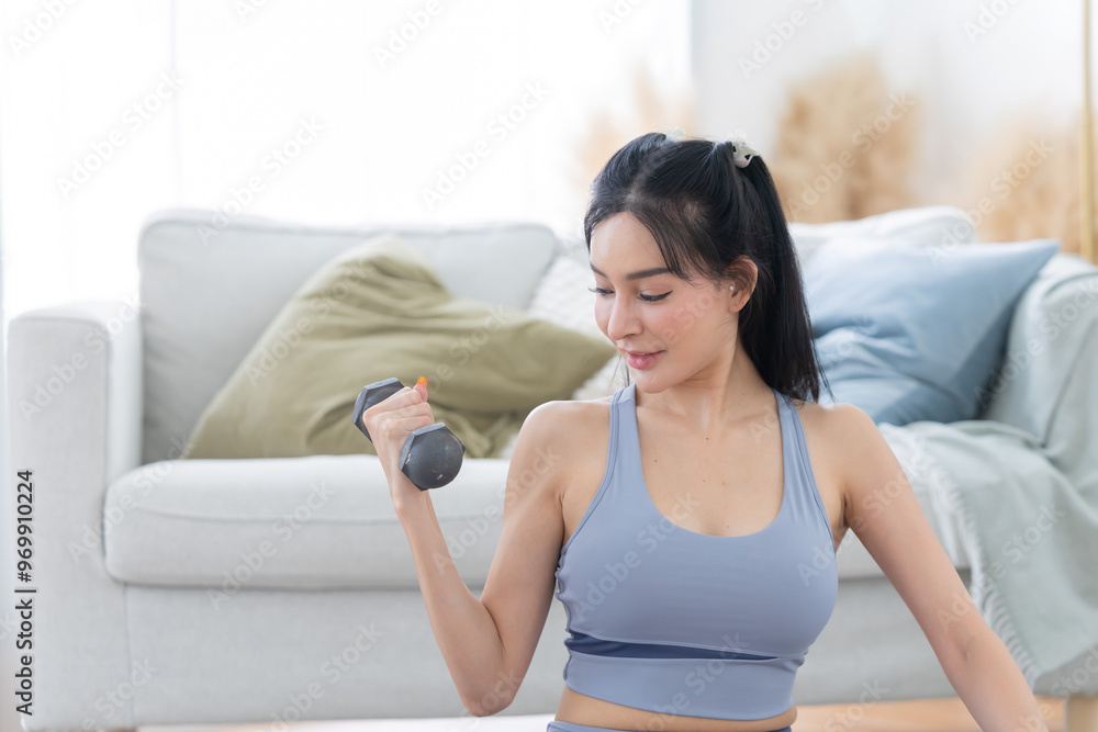 Asian womanexercise with dumbbell at home Asian womanexercise with dumbbell at home