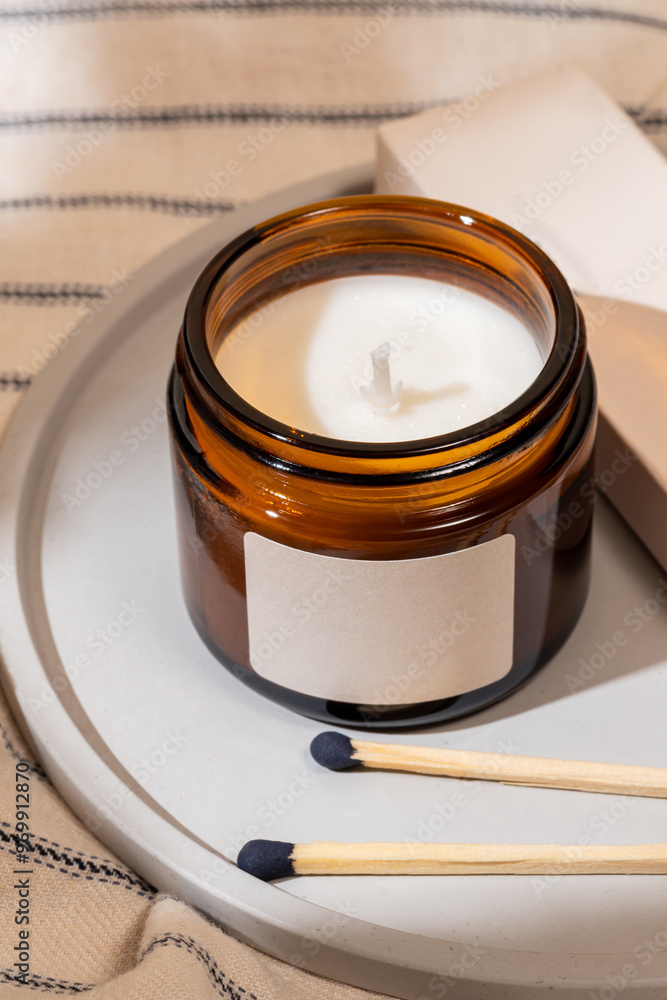 Unlit scented candle in a brown glass jar with matches Unlit scented candle in a brown glass jar with matches