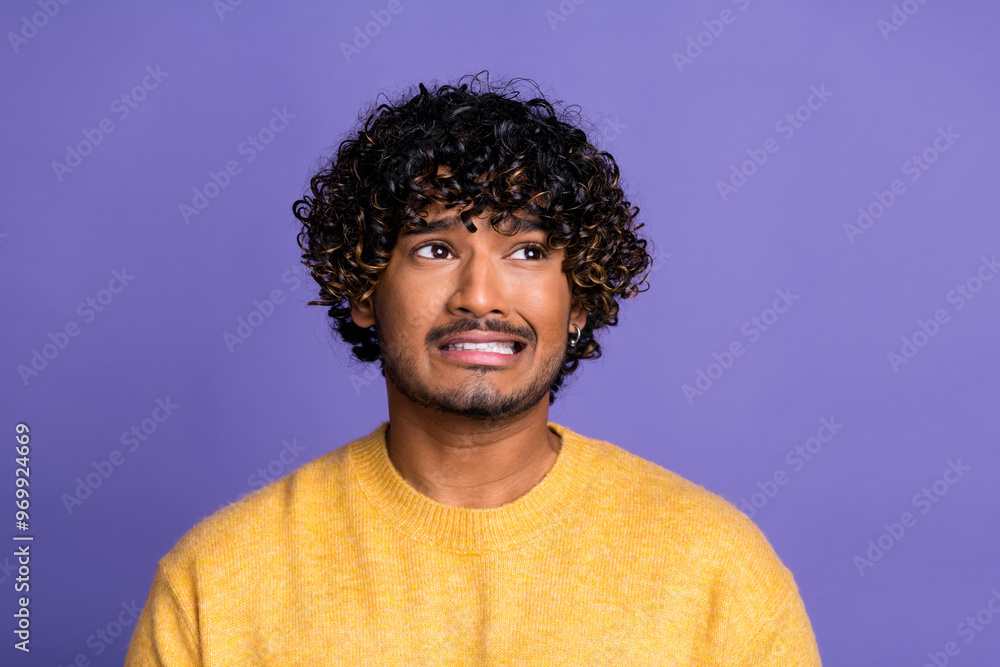 Photo of sad upset funny man wear trendy yellow clothes look empty space isolated on violet color background Photo of sad upset funny man wear trendy yellow clothes look empty space isolated on violet color background
