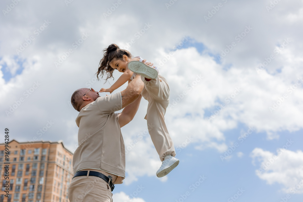 dad plays with his daughter, tosses her in his arms dad plays with his daughter, tosses her in his arms