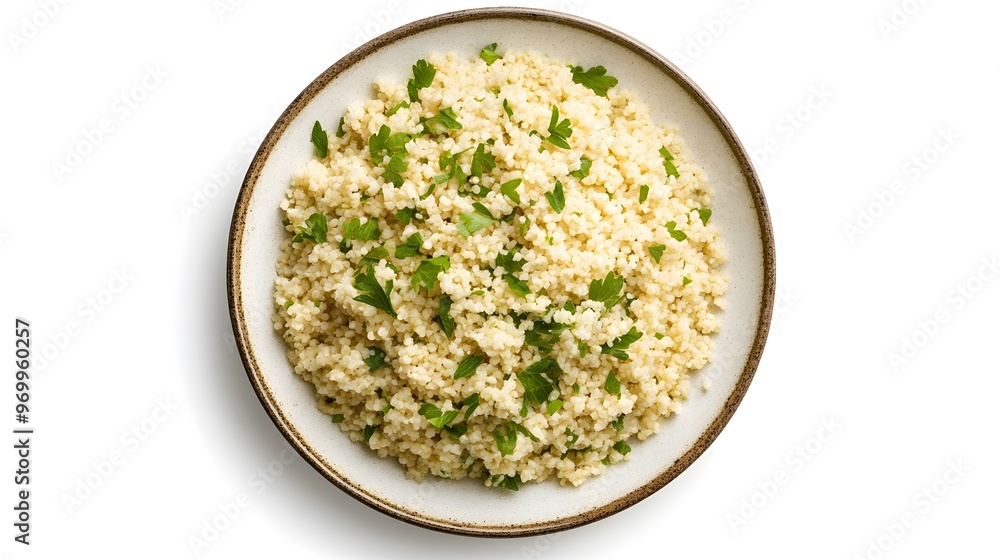 Bowl of fluffy couscous garnished with fresh parsley on a white background Bowl of fluffy couscous garnished with fresh parsley on a white background