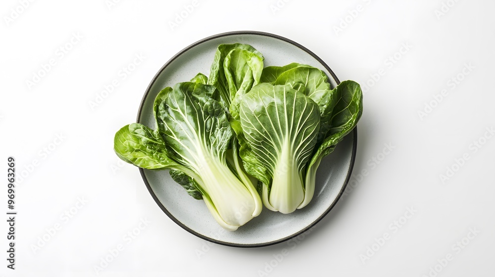 Fresh green bok choy on plate - minimalist vegetable presentation for healthy lifestyle Fresh green bok choy on plate - minimalist vegetable presentation for healthy lifestyle