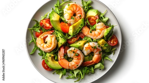 Fresh shrimp and avocado salad with cherry tomatoes and arugula on a white plate