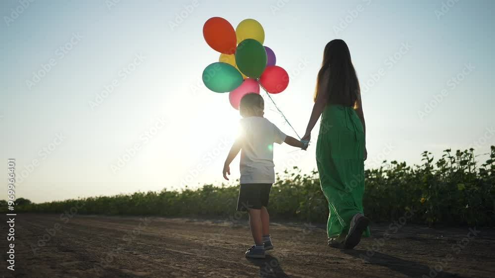 Family running with balloon at sunset. Silhouette of mom and child holding hands. Joyful family moment with balloon. Sunset glow enhances silhouette. Balloon filled fun during sunset with family. Family running with balloon at sunset. Silhouette of mom and child holding hands. Joyful family moment with balloon. Sunset glow enhances silhouette. Balloon filled fun during sunset with family.