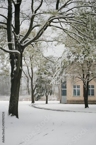 A snowy landscape with soft, warm illumination from the warm interior of a building. 