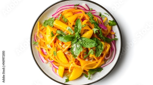 Colorful mango and carrot salad with red onions and fresh basil