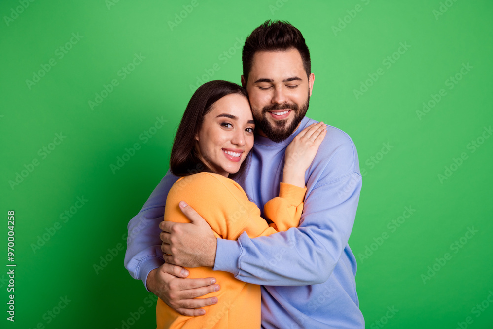 Photo of pretty cute tender charming couple wear stylish clothes isolated on green color background Photo of pretty cute tender charming couple wear stylish clothes isolated on green color background