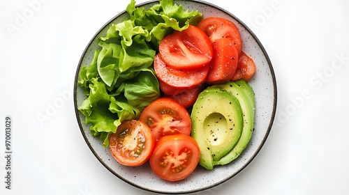 Fresh vegetable salad with tomatoes, avocado, and lettuce on a plate